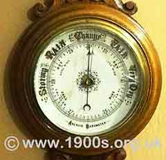 Wall mounted aneroid barometer in carved wooden case