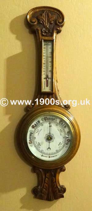 Wall mounted aneroid barometer in carved wooden case