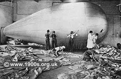 Barrage balloon being checked and mended by workers