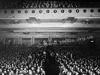 Inside a mid-1900s cinema, showing the large balcony