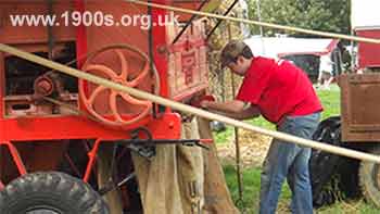 Grain being delivered into sacks from a threshing machine