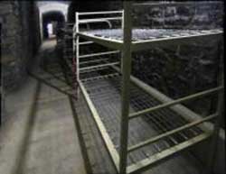 World War Two public shelter under battlements of Cardiff Castle showing rows of bunk beds, small image