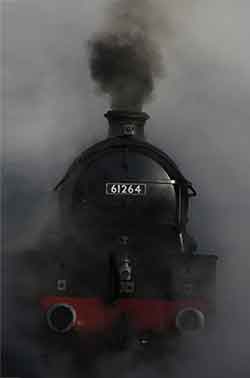 sooty smoke from the engine of a steam train