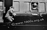 Man jumping from an old British moving train because train doors could be opened by passengers even while moving