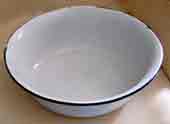 Old white enamel washing-up bowl