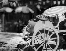 water cart damping down dust in streets, early 1900s