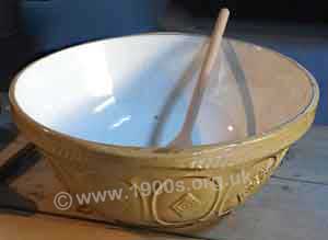 Typical old china mixing bowl, white inside and cream outside with a raised pattern